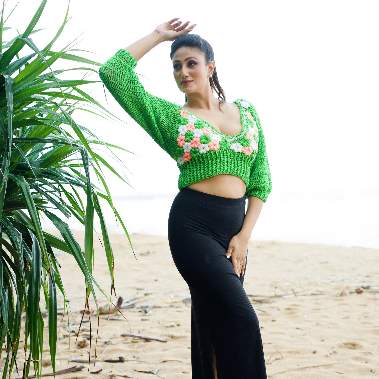 Green crochet top with floral patterns on a white background-veyaro