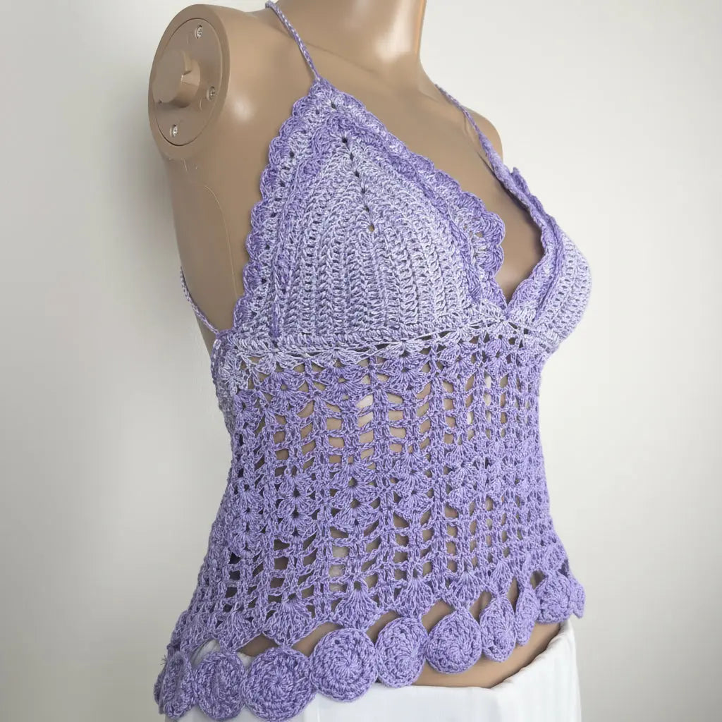 A lavender purple crocheted halter top displayed on a mannequin torso against a plain light background.