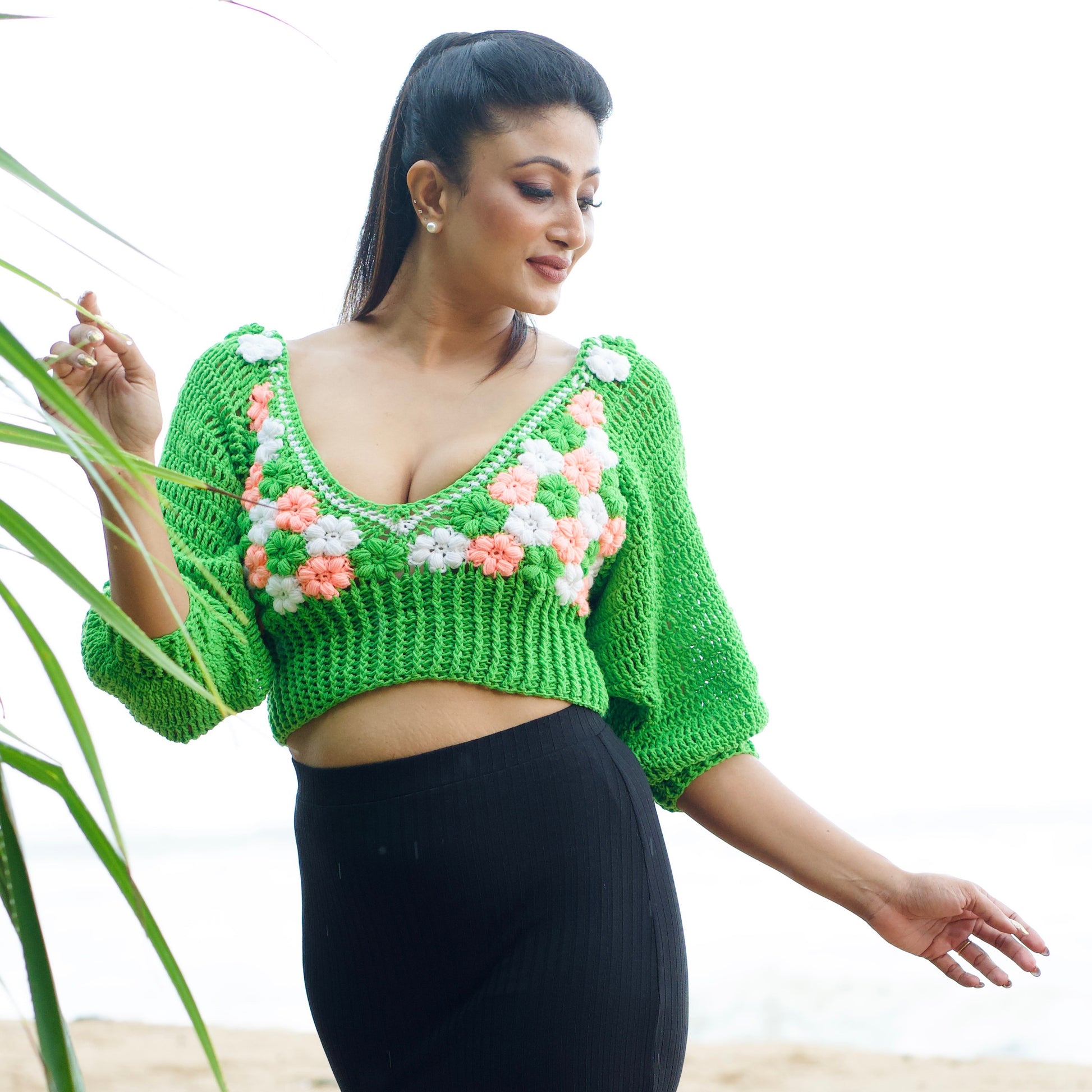 Green crochet top with floral patterns on a white background-veyaro