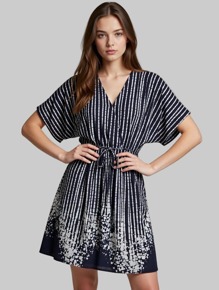 Woman wearing a handmade black and white striped dress against a neutral background