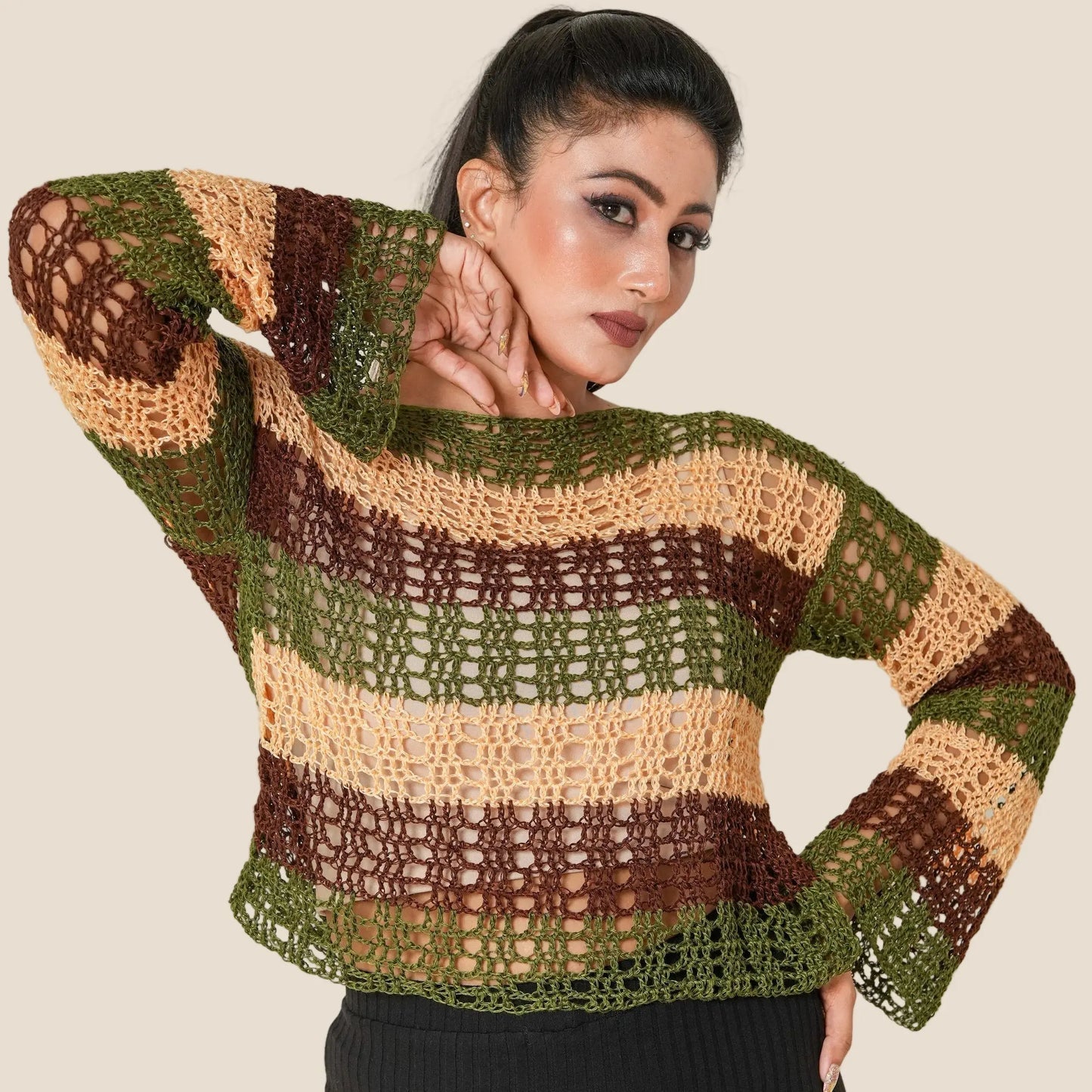 Woman wearing a striped sweater with a plain background