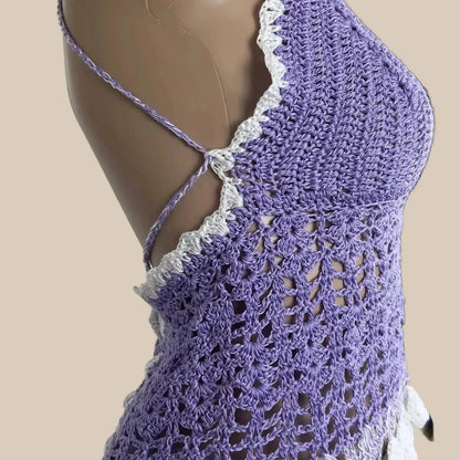 Purple crochet top on a mannequin against a white door background