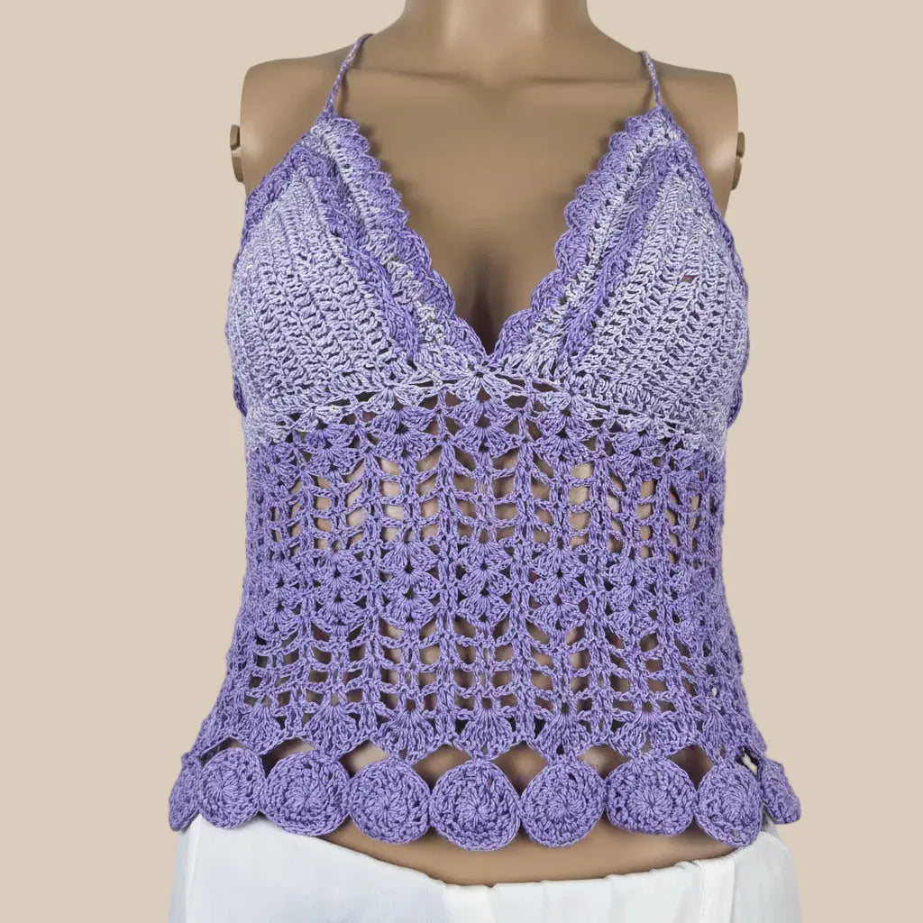 A lavender purple crochet halter top displayed on a mannequin torso against a solid beige background.