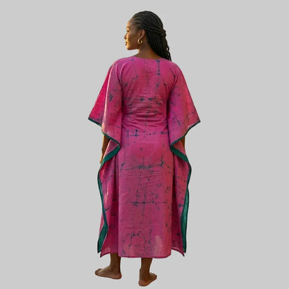 Pink and green batik caftan dress front and back view, lightweight 100% cotton super voile, handmade resort wear on light grey background.