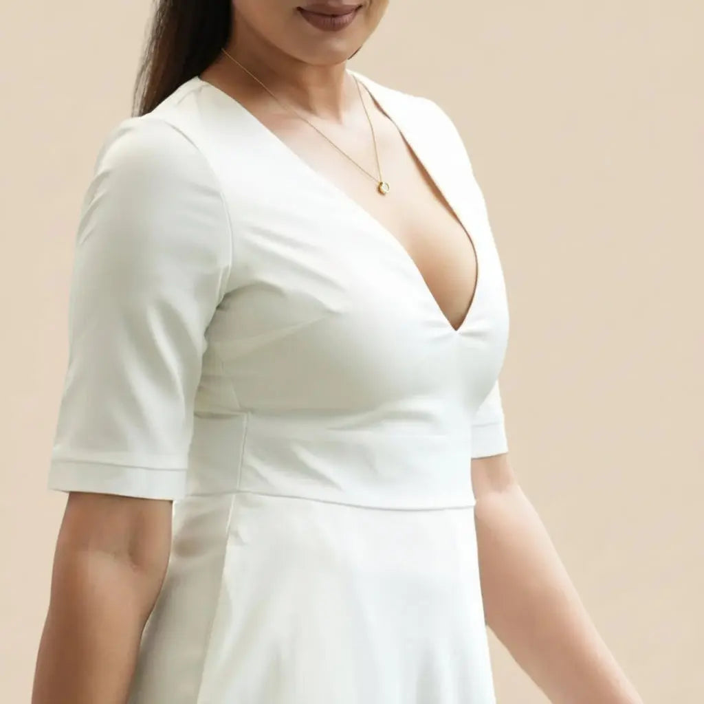 Woman in a white dress holding a brown bag outdoor