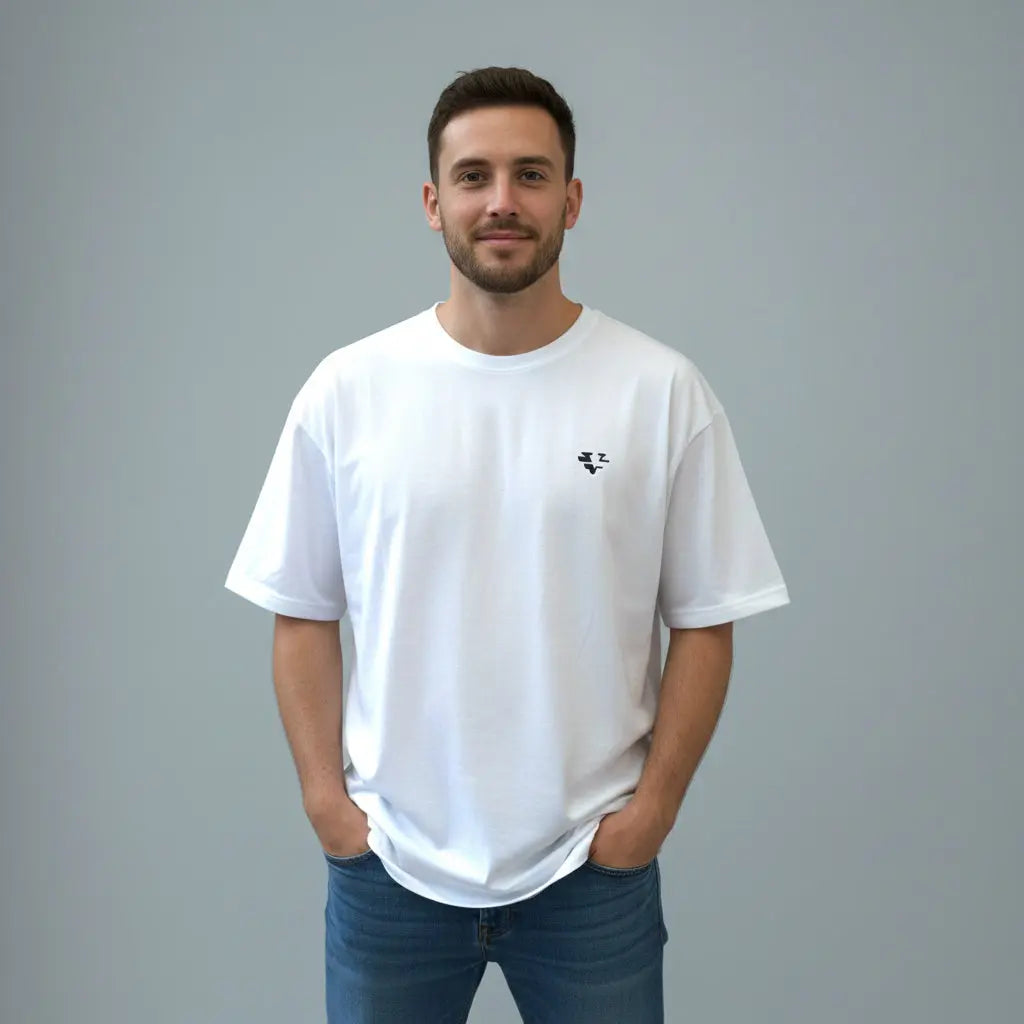 Man wearing a white t-shirt with a small logo, blue jeans, and a red patterned bucket hat against a gray background.