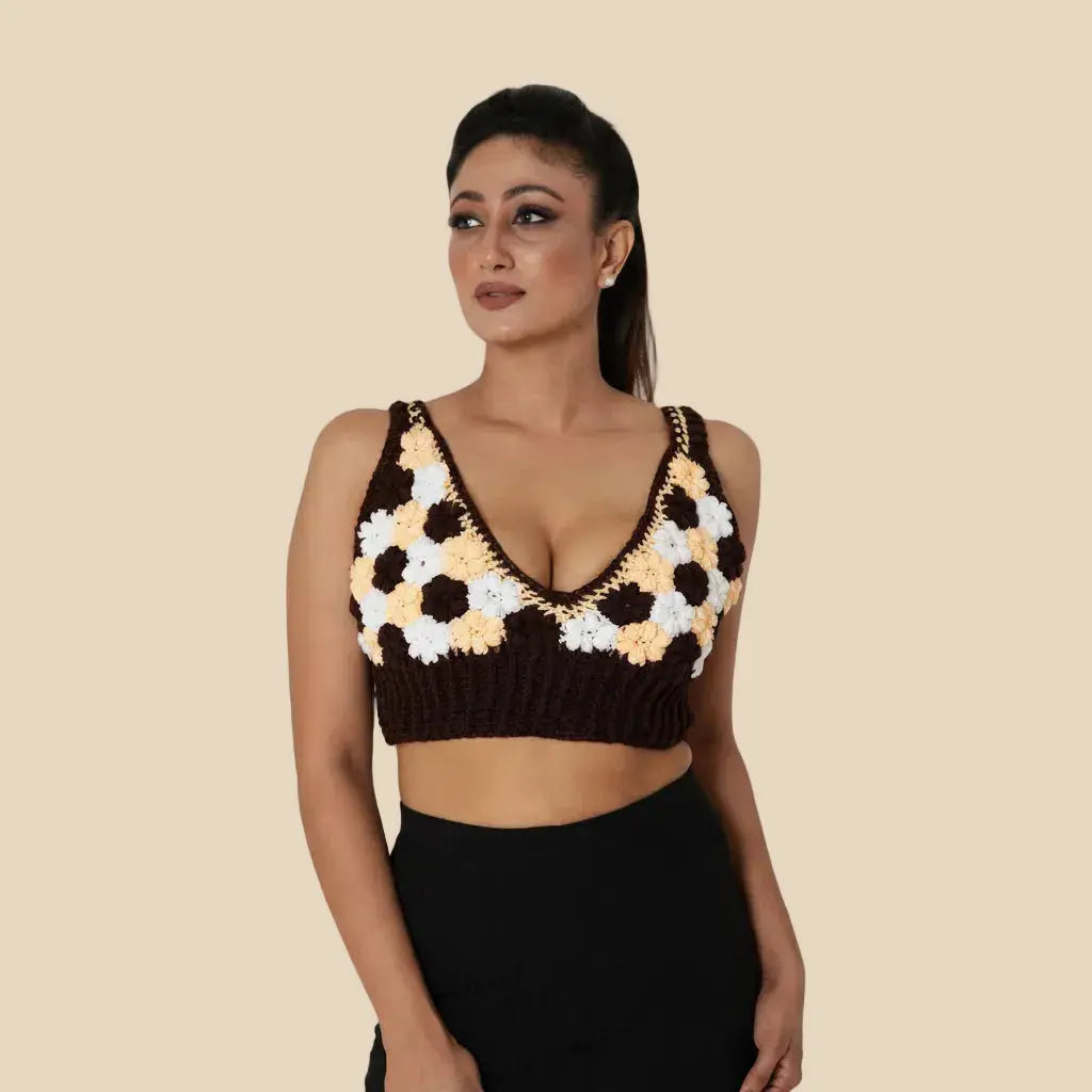 Woman wearing a crochet top with a geometric pattern on a beige background