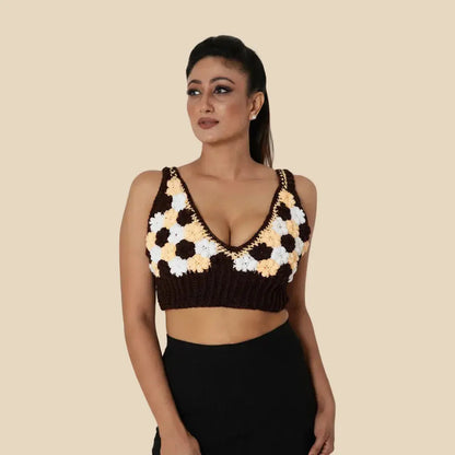 Woman wearing a crochet top with a geometric pattern on a beige background