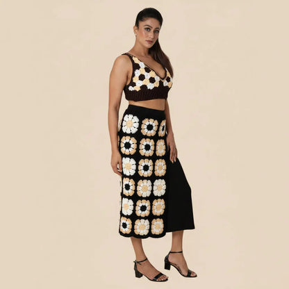 Woman wearing a black and white floral patterned outfit on a beige background